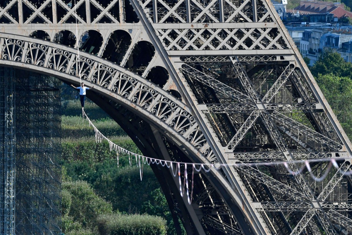 <i>Alain Jocard/AFP/Getty Images</i><br/>Nathan Paulin performs on a 70-meter-high slackline between the Eiffel Tower and the Chaillot Theater on September 18.