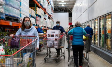 Shoppers wearing masks search for items at a Costco Wholesale store on February 26 in Colchester