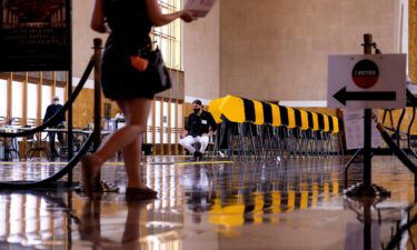 A woman arrives to cast her early ballot for the California gubernatorial recall election at a vote center in Union Station