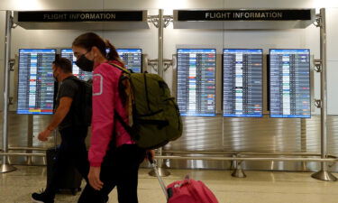 Travelers make their way through the Miami International Airport before starting the Labor Day weekend on September 3 in Miami