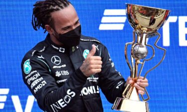 Hamilton celebrates on the podium after winning the Russian Grand Prix.