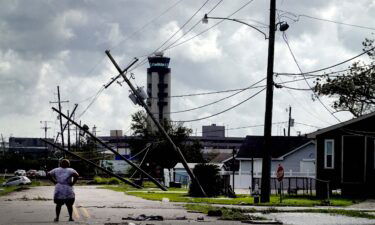 A woman surveys the damage in Kenner