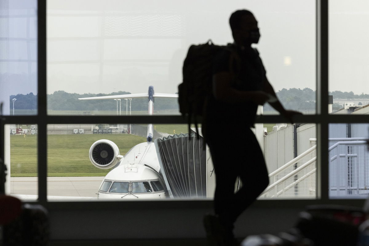 <i>Angus Mordant/Bloomberg/Getty Images</i><br/>The Delta variant is hurting US jobs. We now likely won't see a full recovery until 2023. A traveler here waits to board a flight at Springfield-Branson National Airport in Springfield