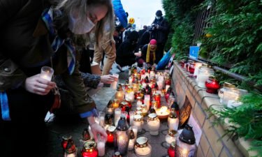 Warsaw residents light candles at the national border guard headquarters