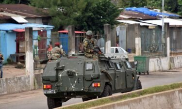 Members of Guinea's armed forces drive through the central neighborhood of Kaloum