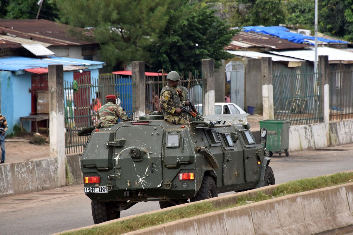 <i>Cellou Binani/AFP/Getty Images</i><br/>Members of Guinea's armed forces drive through the central neighborhood of Kaloum