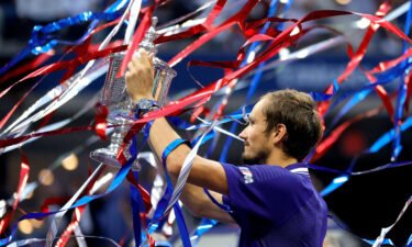 Medvedev celebrates with the US Open trophy.