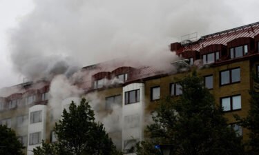 Smoke billows from a building as emergency services fight a fire caused by an explosion in central Gothenburg.
