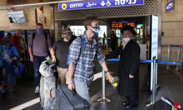 Tourists walk at the Ben Gurion International Airport after entering Israel by plane