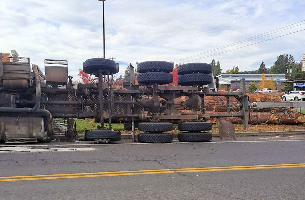 Driver was unhurt in NE Bend log truck rollover crash, police say