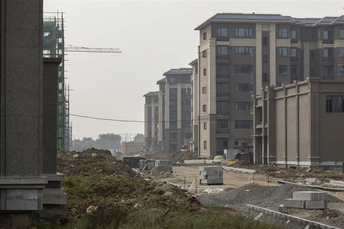 <i>Qilai Shen/Bloomberg/Getty Images</i><br/>Embattled conglomerate Evergrande and other developers have warned they could default on their huge debts. Pictured is an unfinished apartment building in Nanjing