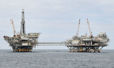 Experts are warning that the climate crisis could trigger the next financial meltdown. The oil platforms named Ellen (L) and Elly (R) are seen off the southern California coast on October 6