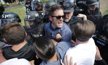 White nationalist Richard Spencer (C) and his supporters clash with Virginia State Police in Emancipation Park after the "Unite the Right" rally was declared an unlawful gathering on August 12