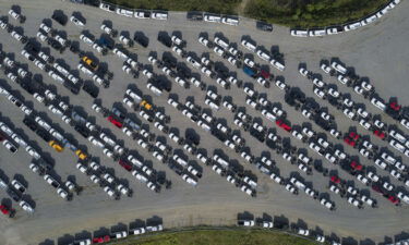 America's factories have struggled with shortages of materials and qualified workers. New Ford F-Series pickup trucks are shown here stored in a lot during a semiconductor shortage at Kentucky Speedway in Sparta