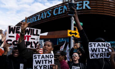 Protesters rallying against COVID-19 vaccination mandates and in support of basketball player Kyrie Irving gather in the street outside the Barclays Center before an NBA basketball game between the Brooklyn Nets and the Charlotte Hornets