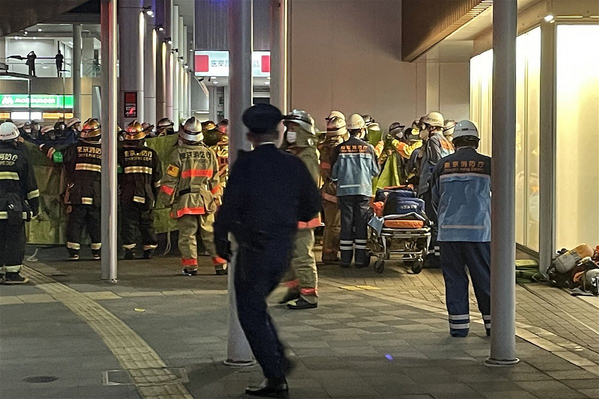 <i>STR/Jiji Press/AFP/Getty Images</i><br/>Firefighters and rescue workers gather outside Kokuryo Station on the Keio line in the city of Chofu in western Tokyo on October 31