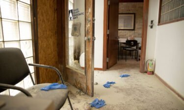 A rock remains on the floor at the Travis County Democratic Party office in Austin after someone threw a rock and an incendiary device into the building.