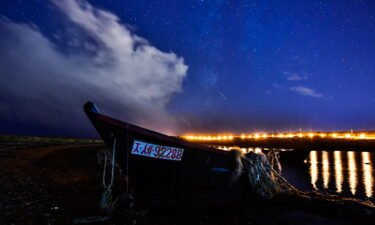 A meteor streaks across the night sky over Russky Island during the Draconid meteor shower. The Draconid meteor shower is expected to peak on Friday