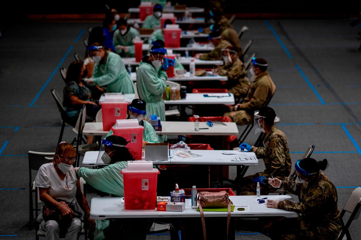 <i>RICARDO ARDUENGO/AFP/AFP via Getty Images</i><br/>Senior citizens receive Covid-19 vaccines at a National Guard vaccination center in San Juan on February 8.