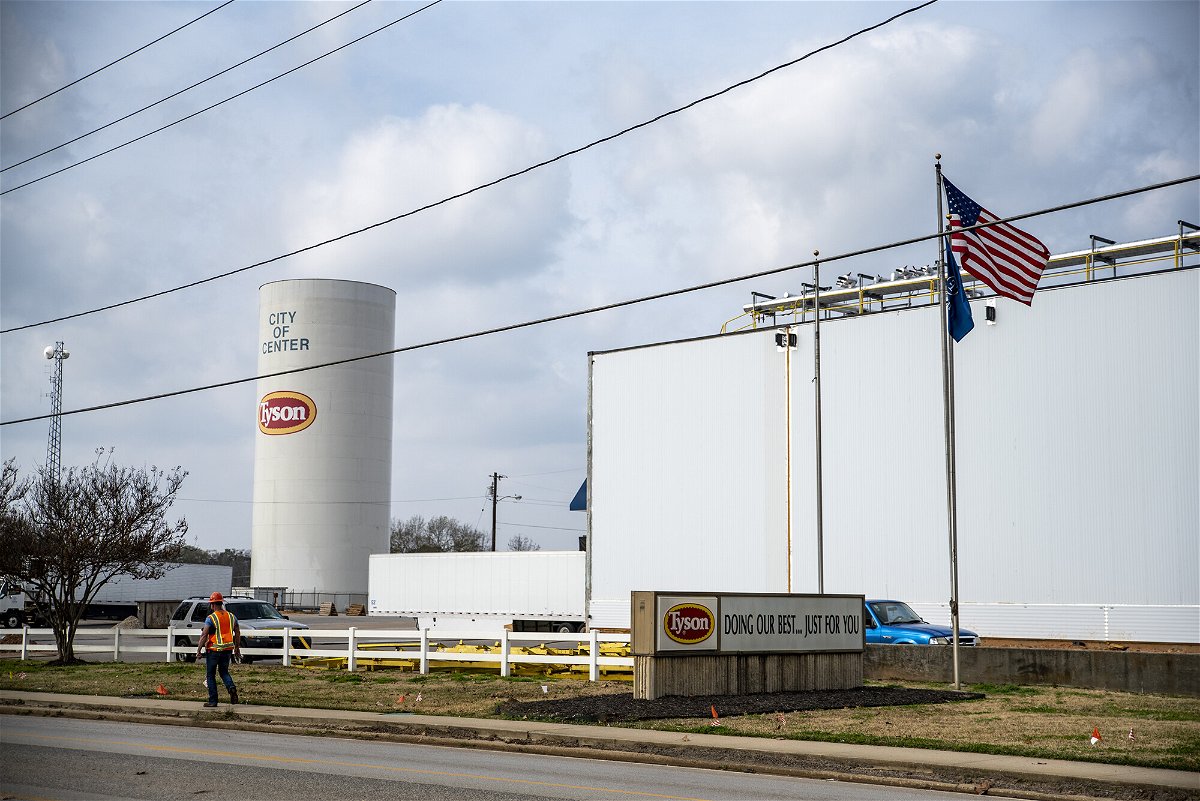 <i>Sergio Flores/Bloomberg/Getty Images</i><br/>96% of Tyson's active workers are vaccinated. A worker walks past the Tyson Foods Inc. processing plant in Center