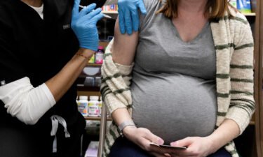 A pregnant woman receives a vaccine for the coronavirus disease (COVID-19) at Skippack Pharmacy in Schwenksville