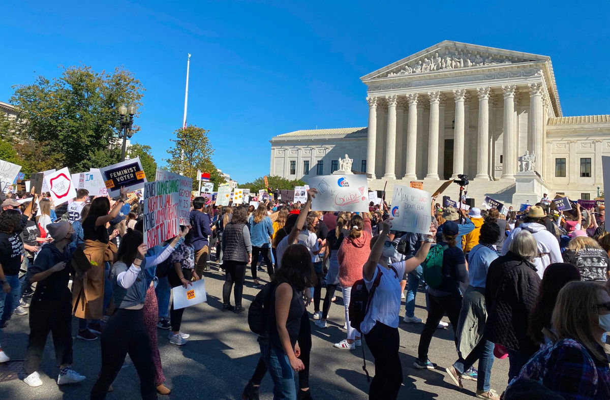 <i>Daniel Slim/AFP/Getty Images</i><br/>Demonstrators march past the Supreme Court in the nationwide Women's March on October 17