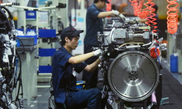 An unfolding crisis in real estate is emerging as one of Beijing's toughest challenges. Workers are shown here assembling truck engines at a subsidiary factory of the China National Heavy Duty Truck Group in Hangzhou in east China's Zhejiang province