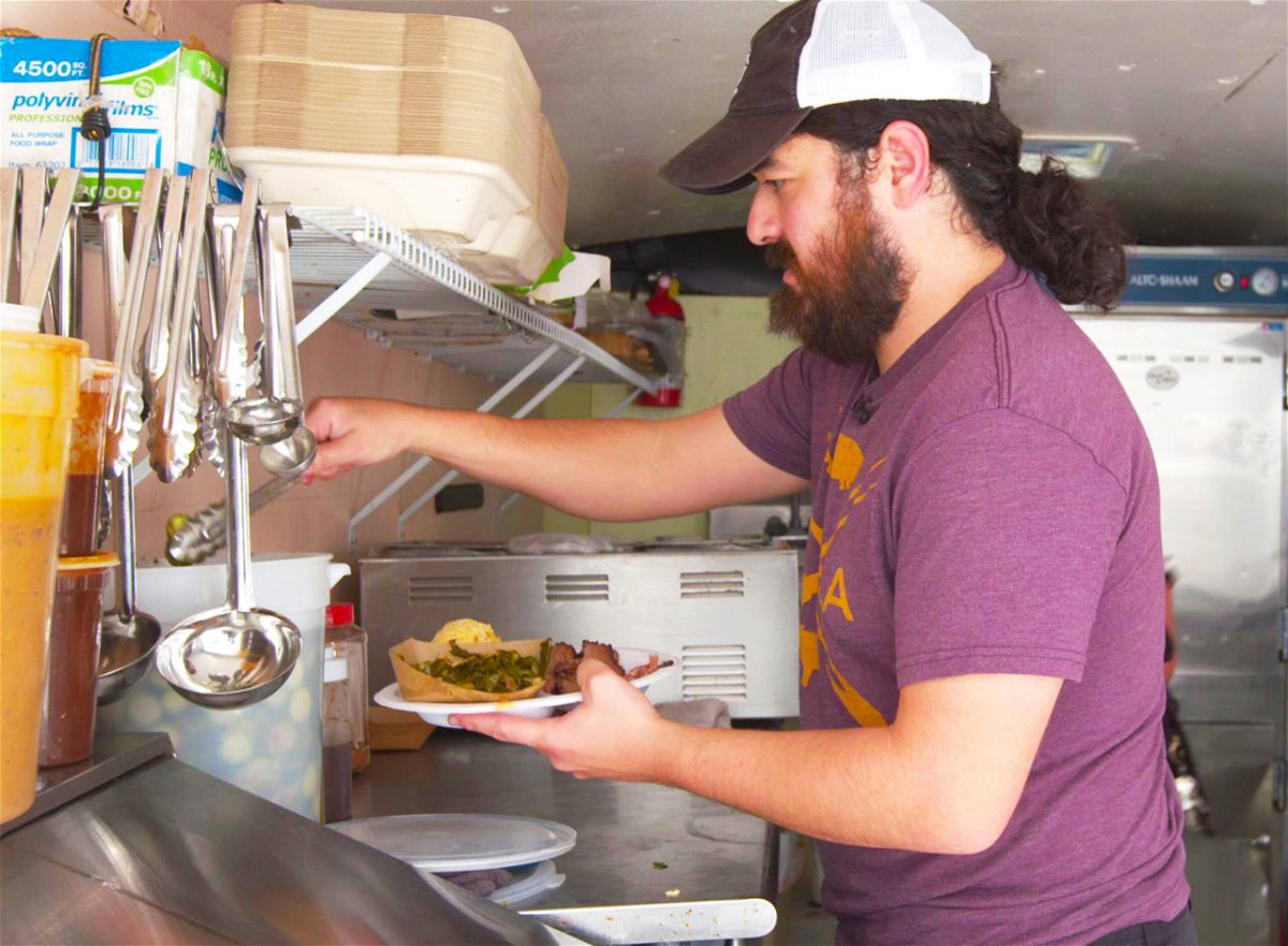 <i>Jeremy Harlan/CNN</i><br/>Alex Barbosa preps a plate of barbecue in his mobile barbecue trailer Barbosa's Barbeque.