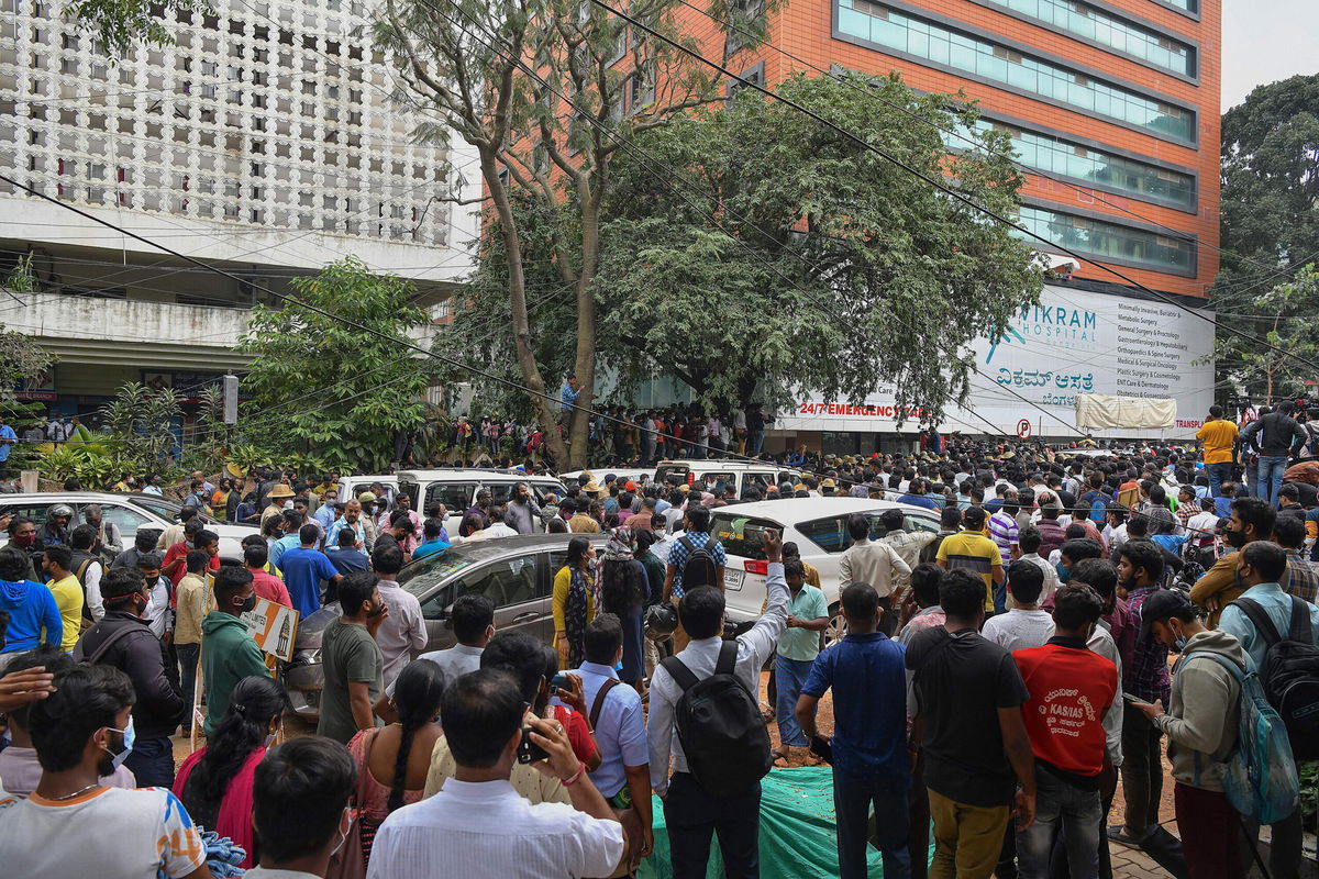 <i>Manjunath Kiran/AFP/Getty Images</i><br/>Fans of Kannada cinema actor Puneeth Rajkumar wait outside a private hospital after news of his admission in Bangalore on October 29.