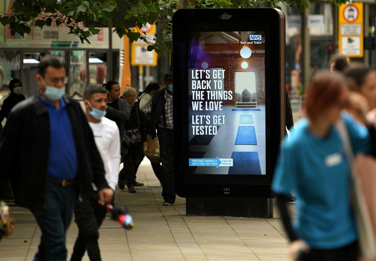 <i>Oli Scarff/AFP/Getty Images</i><br/>Pedestrians walk past an electronic display board promoting the 