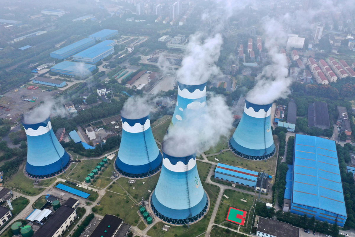 <i>Chinatopix/AP</i><br/>A global energy crunch caused by weather and a resurgence in demand is getting worse. Steam is shown billowing out of the cooling towers at a coal-fired power station in Nanjing