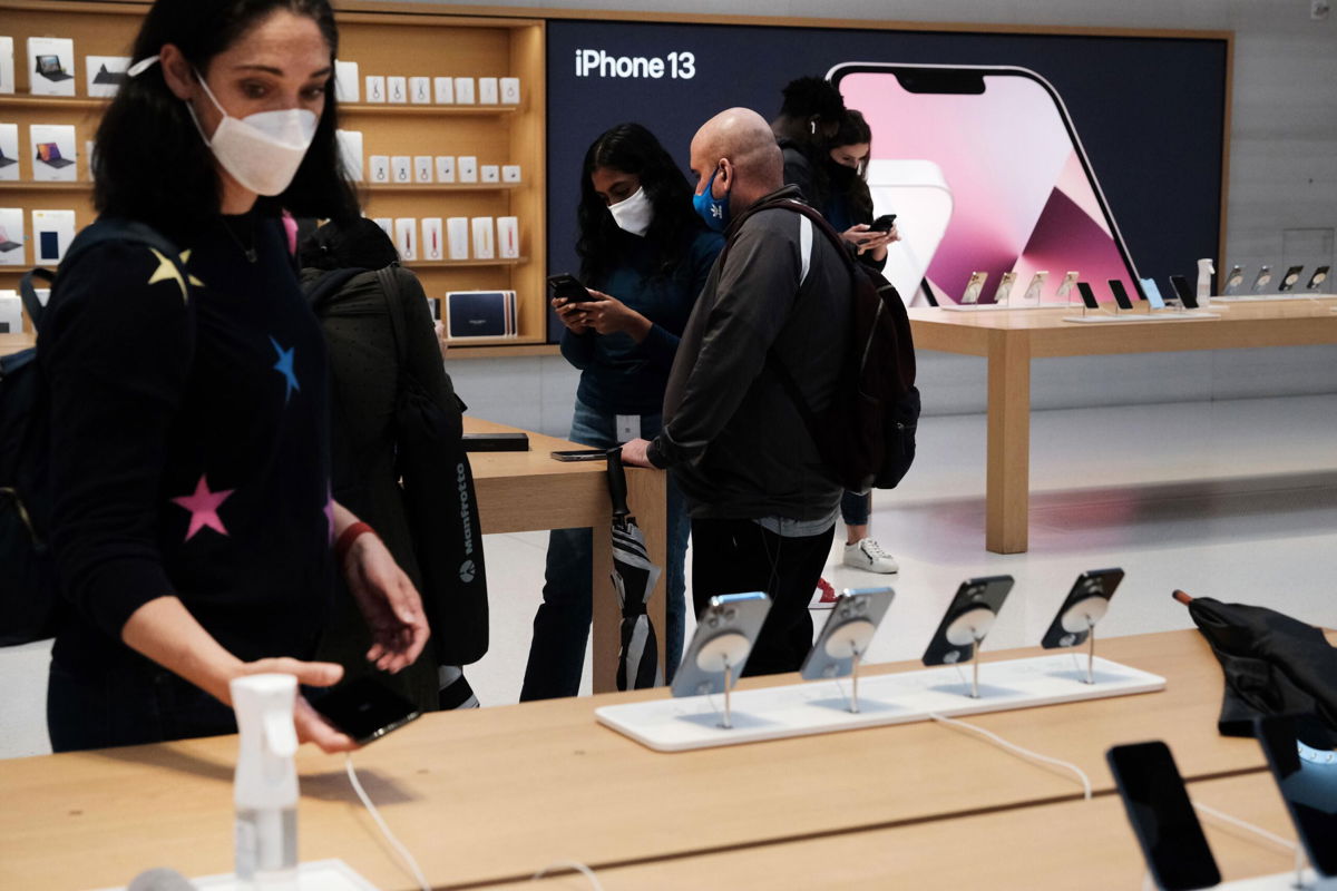 <i>Spencer Platt/Getty Images</i><br/>People shop at the Fifth Avenue Apple Store during the launch of Apple's new iPhone 13 and iPhone 13 Mini on September 24 in New York City.