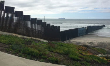 A woman was pronounced dead early Saturday morning after trying to swim across the US-Mexican border with a group of migrants. The western-most part of the US-Mexican border shown here overlooks the Pacific Ocean