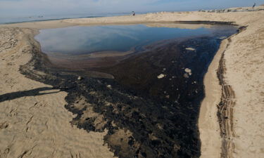 Oil is shown washed up in Huntington Beach