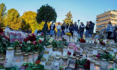 Flowers and candles are placed at a makeshift memorial for the victims of the Kongsberg attack on Stortorvet in Kongsberg