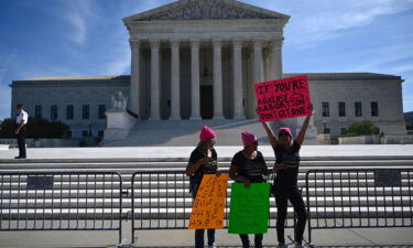 Protesters hold signs in front of the Supreme Court during the Women's March and Rally for Abortion Justice in Washington