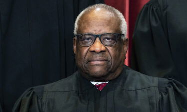 Associate Justice Clarence Thomas sits during a group photo at the Supreme Court in Washington
