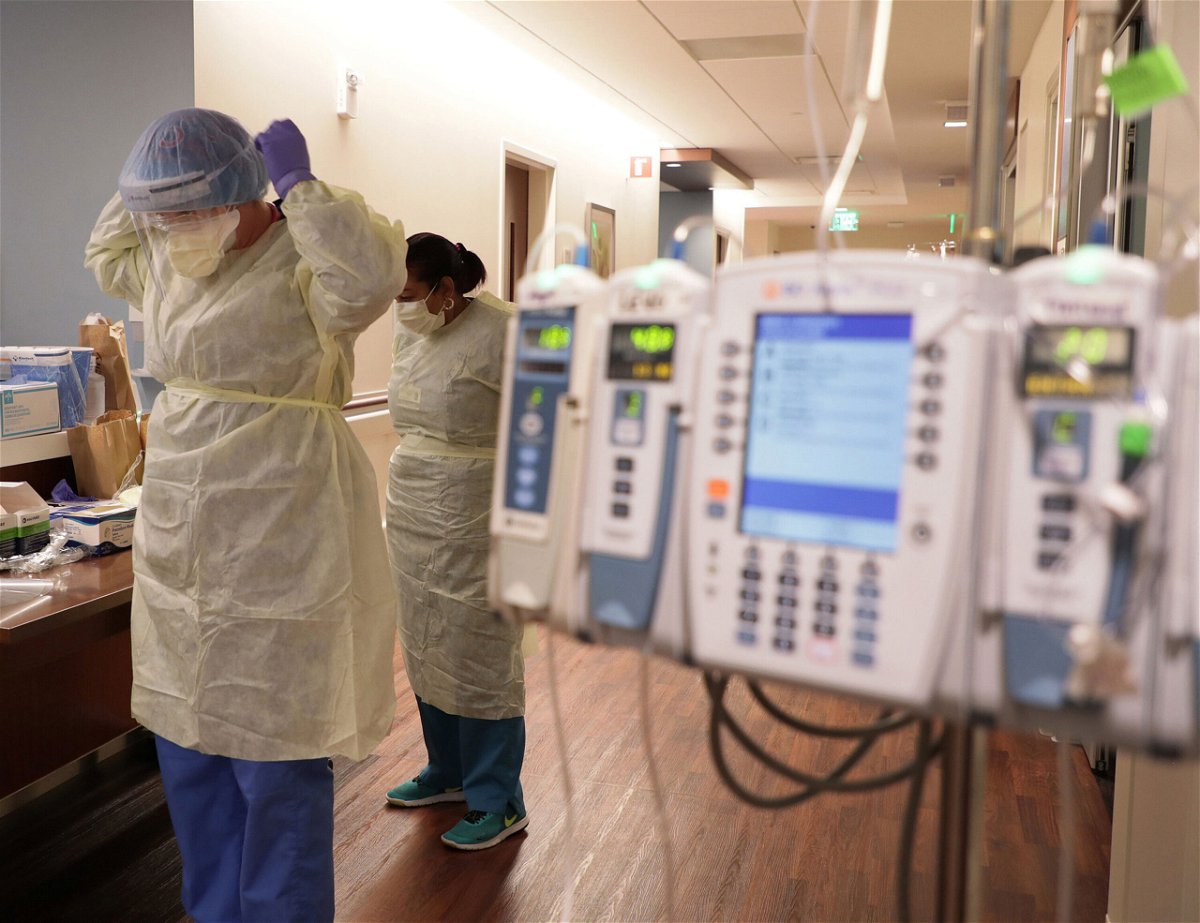 <i>Chicago Tribune/Tribune News Service/Getty Images</i><br/>Hospital staff don personal protective equipment before entering the room of a Covid-19 patient at the Northwestern Medicine Lake Forest Hospital ICU in Illinois.