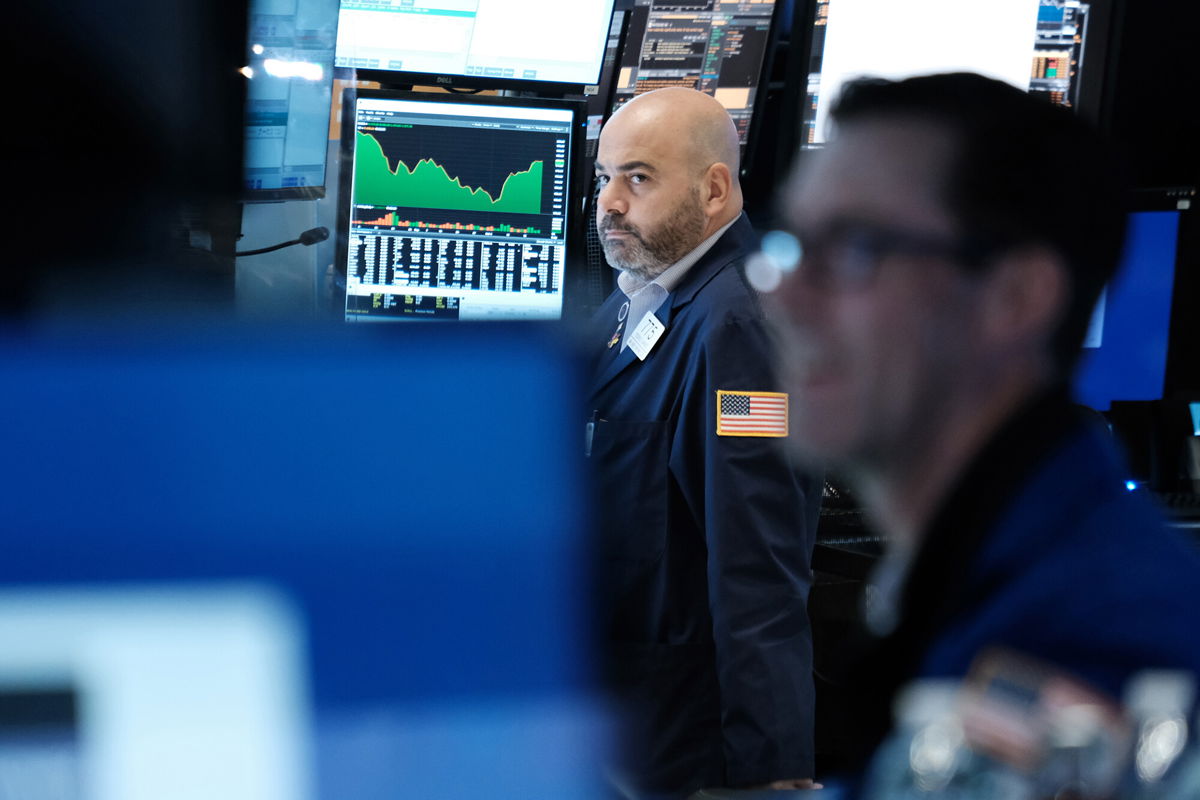 <i>Spencer Platt/Getty Images</i><br/>Traders work on the floor of the New York Stock Exchange (NYSE) on October 25 in New York City.