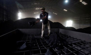 India may be staring at electricity shortages in the coming months because coal stocks at most of its power plants have dropped to critically low levels. A laborer is shown here working inside a coal yard on the outskirts of Ahmedabad