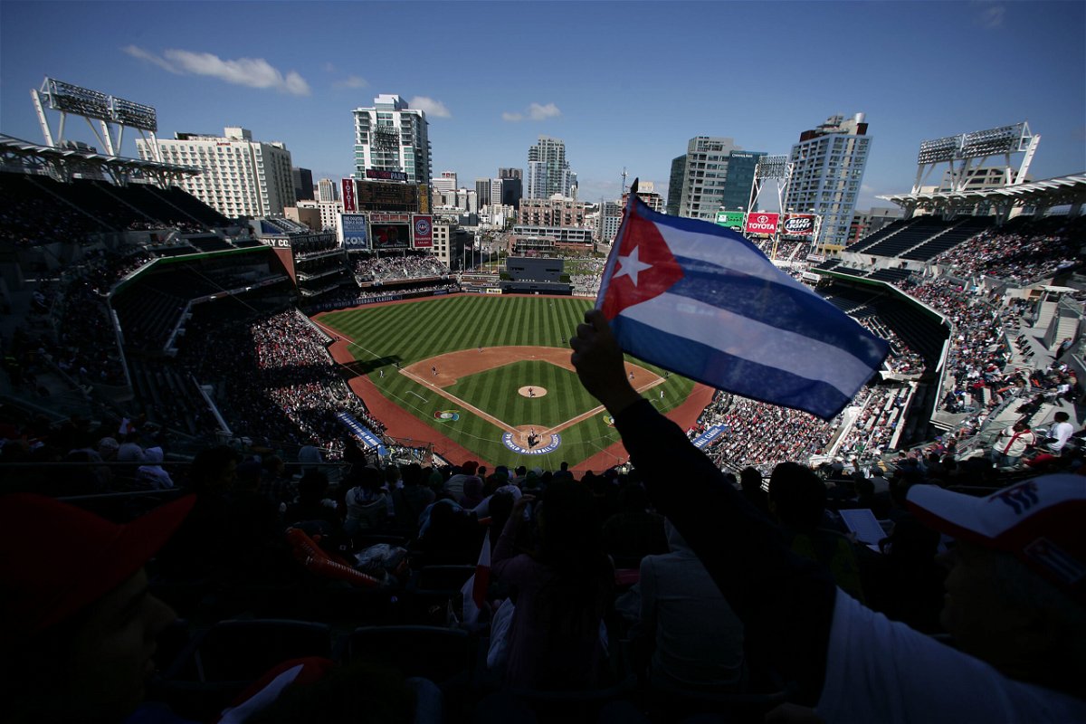 <i>Donald Miralle/Getty Images North America/Getty Images</i><br/>Cuba's state media on Sunday lashed out after nearly a dozen Cuban baseball players defected in Mexico -- believed to be one of the country's largest and most embarrassing known incidents of mass defection in years. A Cuban flag is held at Petco Park in San Diego