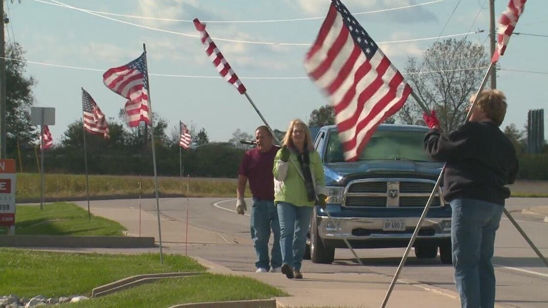 <i>KMOV</i><br/>Volunteers plant flags along the funeral route of fallen Pontoon Beach Police Officer Tyler Timmins on October 31.