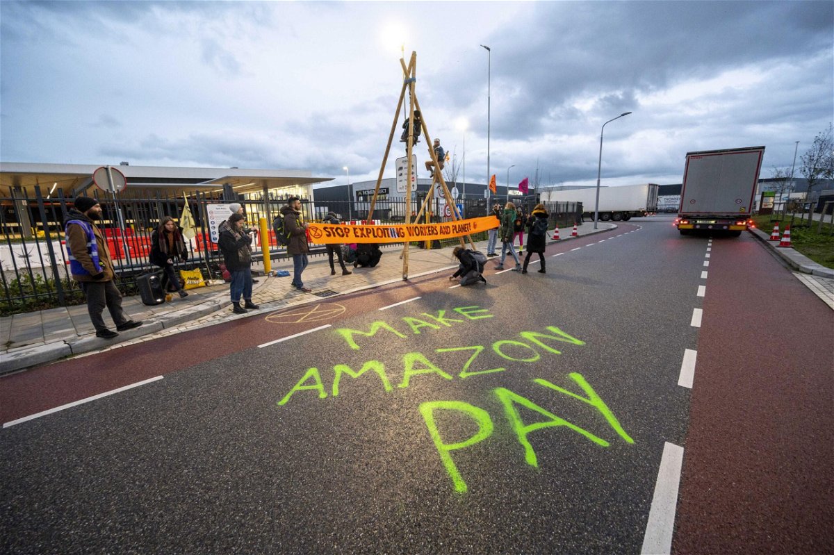 <i>Evert Elzinga/EPA-EFE/Shutterstock</i><br/>Extinction Rebellion activists block the access to the distribution center of e-commerce company Amazon in Rozenburg-Schiphol