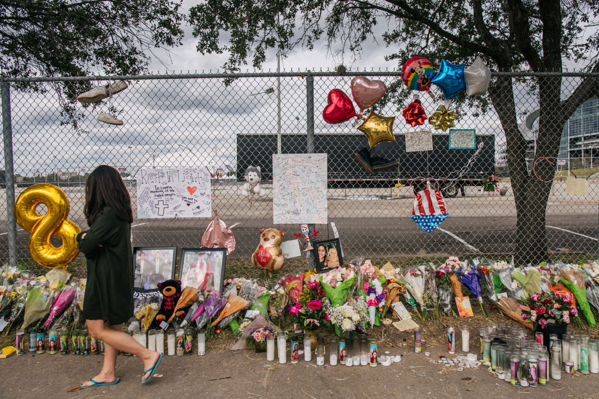 <i>Brandon Bell/Getty Images</i><br/>A woman walks past a memorial to those who died at the Astroworld festival outside of NRG Park on November 09