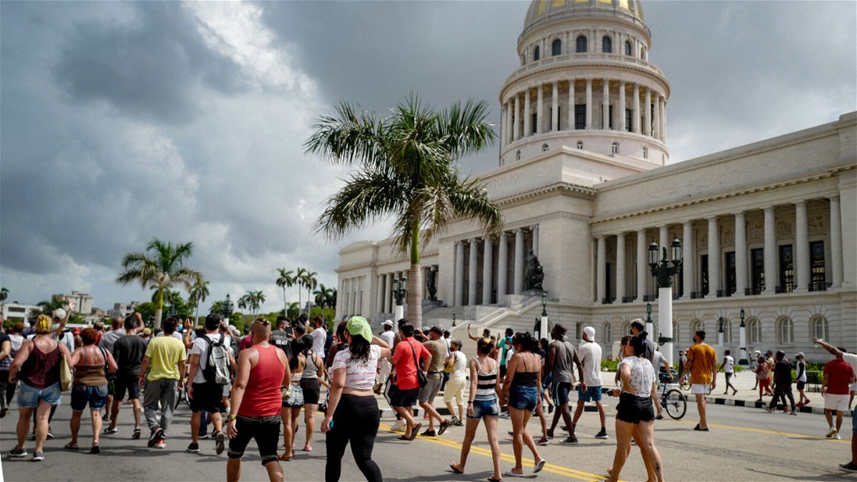 <i>Adalberto Roque/AFP/Getty Images</i><br/>Cubans march in front of Havana's Capitol during a demonstration against the government of Cuban President Miguel Diaz-Canel in Havana