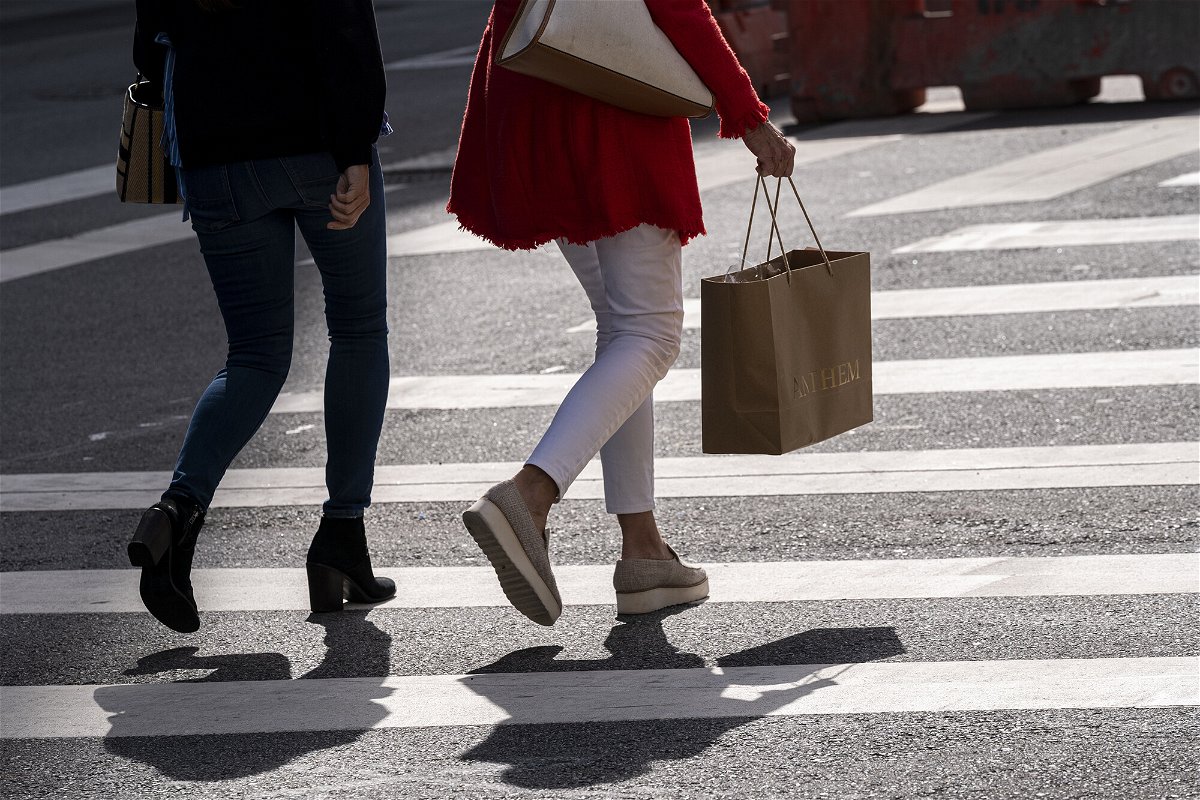 <i>David Paul Morris/Bloomberg/Getty Images</i><br/>US price surges eased in the third quarter of the year. A pedestrian carries a shopping bag in San Francisco