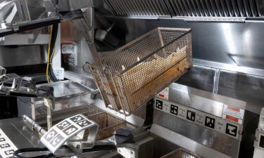 White Castle has plans to roll out Flippy 2 in up to 10 of its 360 total restaurants. Flippy is seen frying fries.