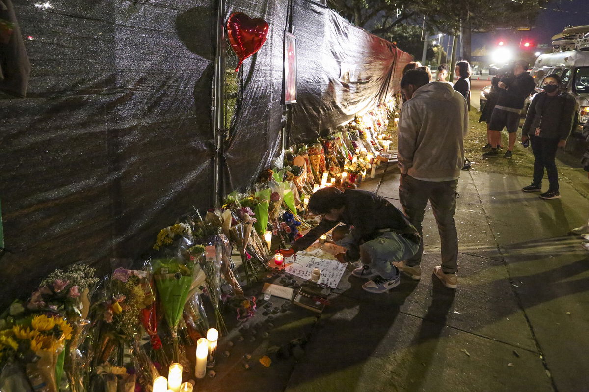 <i>Thomas Shea/AFP/Getty Images</i><br/>Nike has postponed the release of its latest sneaker collaboration with Travis Scott following the Astroworld concert tragedy that left 10 people dead. People attend a makeshift memorial on November 7