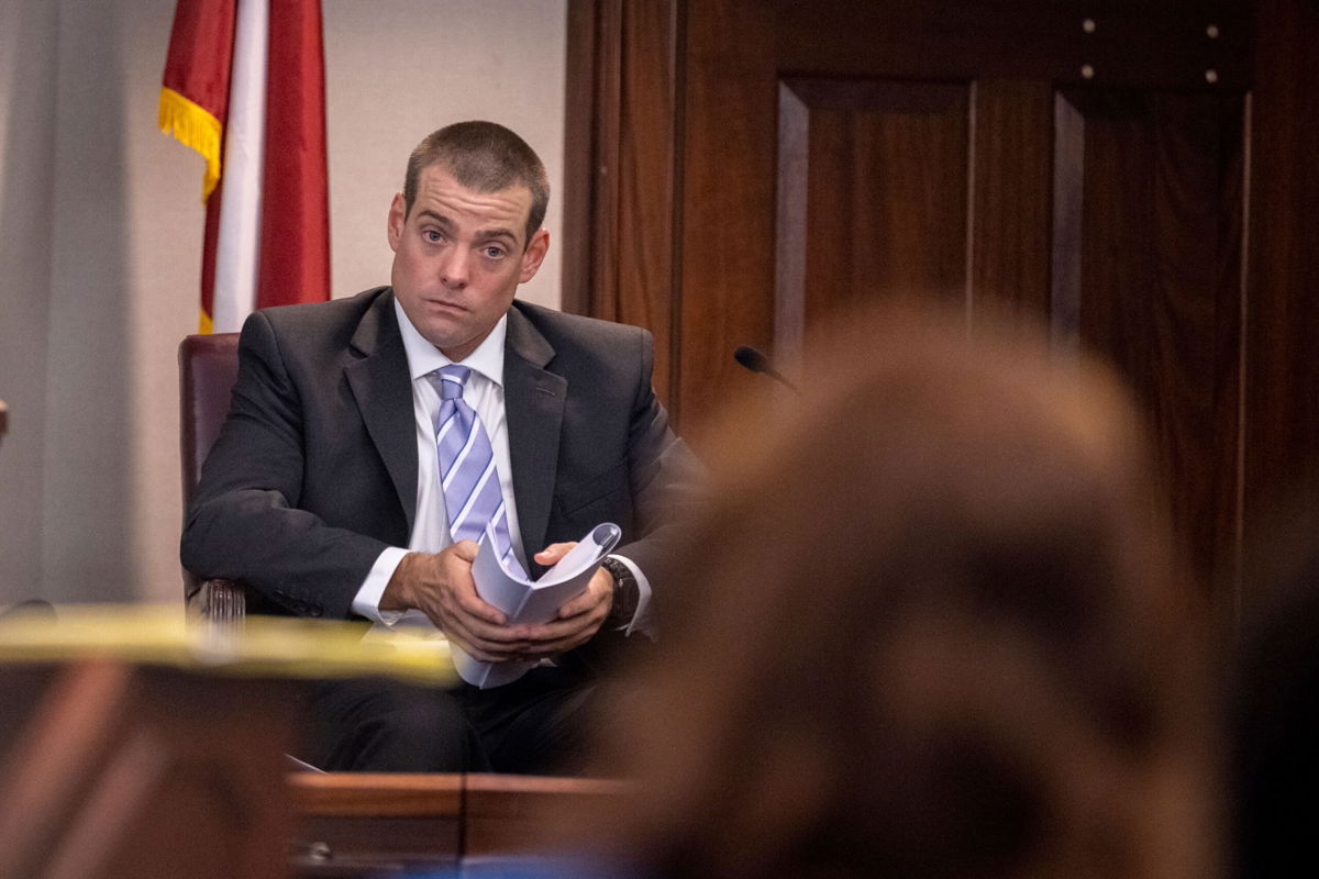 <i>Stephen B. Morton/AP</i><br/>Glynn County police Officer Jeff Brandeberry sits on the witness stand Tuesday in Brunswick