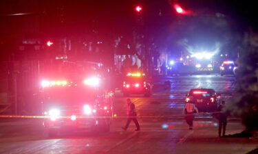 Police investigate at the scene of a crash involving multiple people and injuries at a holiday parade in Waukesha